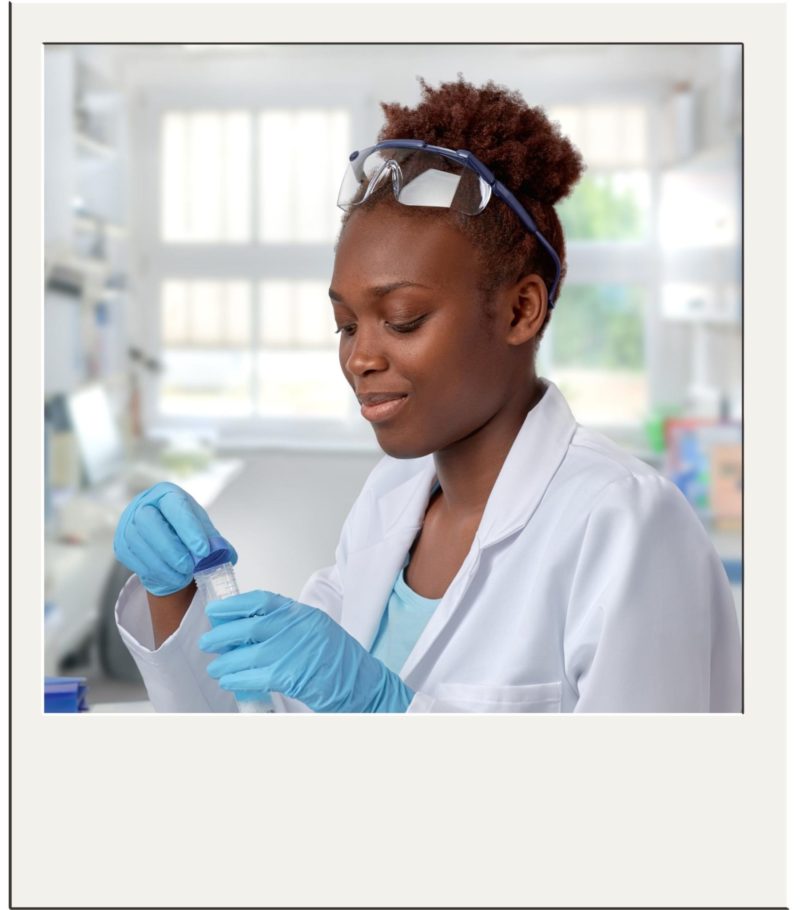 Female researcher in lab coat and gloves