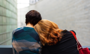 Two people sat together close